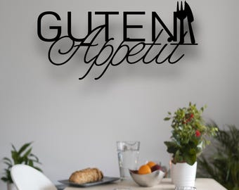 May include: A dining room scene with a wooden table set for a meal. The table is set with white bowls, glasses, and silverware. A black metal sign on the wall reads "Guten Appetit". Plants and food items are also visible.