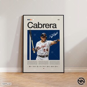 May include: A framed poster featuring a baseball player in a Detroit Tigers uniform, holding a bat. The poster has the name "Cabrera" in large letters, with the number "24" visible on the jersey. The poster includes a signature and text.