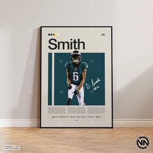 May include: A framed poster featuring a football player in a green and white uniform with the number 6. The poster has the name "Smith" in large letters, a signature, and the number "/98". The background is a teal color.