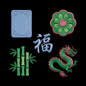 May include: A collection of five embroidered patches on a black background: a light blue rectangular frame, a green and pink flower, a blue Chinese character for fortune, a green bamboo stalk, and a green and pink dragon with a curved body.