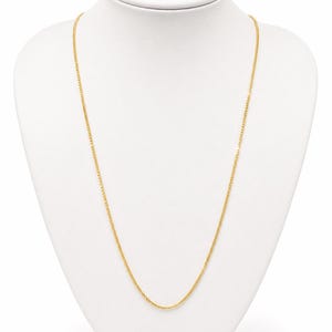 May include: A thin, yellow gold chain necklace featuring a delicate, interlocking wheat or spiga link design. The chain is uniform in color and texture, displaying a bright, polished metallic finish that hangs in a simple, smooth, and continuous loop.