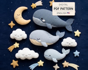 May include: A digital PDF pattern in English featuring plush designs of three whales in varying shades of blue, a yellow crescent moon with a face, three white clouds with faces, and several yellow and blue stars and shooting stars.