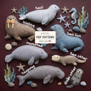 May include: A digital PDF pattern in English featuring felt marine animal shapes including a walrus, seal, sea lion, manatee, dugong, sea otter, and river otter, accompanied by felt starfish, seaweed, and stones, all labelled with their names.