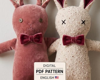 May include: Two plush rabbit dolls with bow ties. The left rabbit is dusty rose velvet with button eyes and floral inner ears. The right rabbit is cream textured fabric with stitched X eyes. A label reads: DIGITAL PDF PATTERN ENGLISH.