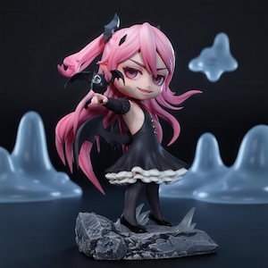 May include: A chibi-style anime figurine with long pink hair, pointed ears, and black bat wings. The character wears a black dress with a white ruffled hem and holds a small black bat figure. The figure stands on a textured gray rock base.