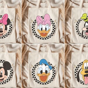 May include: Six beige tote bags featuring Disney characters. Each bag has a circular design with a black and white checkered border. Characters include Minnie Mouse, Daisy Duck, Goofy, Mickey Mouse, Donald Duck, and Pluto.