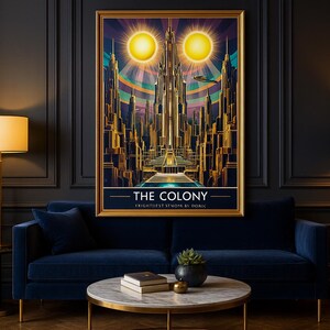 May include: A framed art print titled "The Colony" depicts a futuristic city with two suns. The artwork features gold, blue, and purple hues, and is displayed above a blue velvet sofa. A gold floor lamp and a side table with a lamp are also visible.