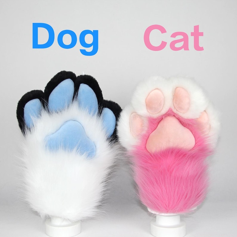 May include: Two furry paw gloves, one white with black and blue accents, the other white with pink accents. The word "Dog" is written above the first paw in blue, and "Cat" is written above the second paw in pink.