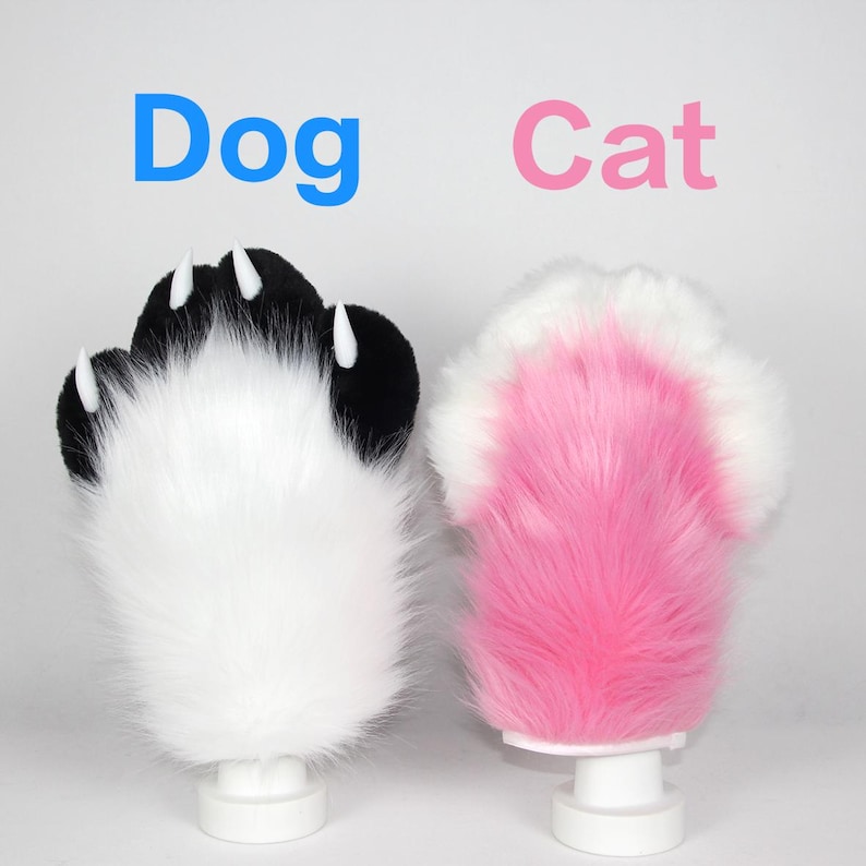 May include: Two plush paw props, one black and white, the other pink and white. The black and white paw has white claws and the word "Dog" in blue above it. The pink and white paw has the word "Cat" in pink above it.