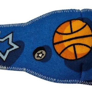 May include: Blue eye patch with a basketball, star, and a small star design. The patch has an elastic strap and a blue loop.