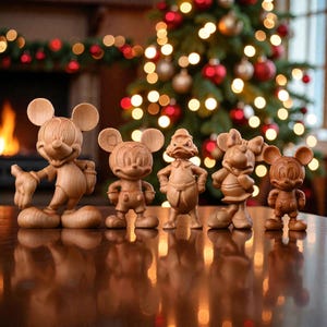 May include: A collection of five wooden Disney character figurines, including Mickey Mouse, Minnie Mouse, and Donald Duck, are displayed on a reflective surface. The figurines are carved from light-colored wood and stand in front of a Christmas tree with red and gold ornaments.