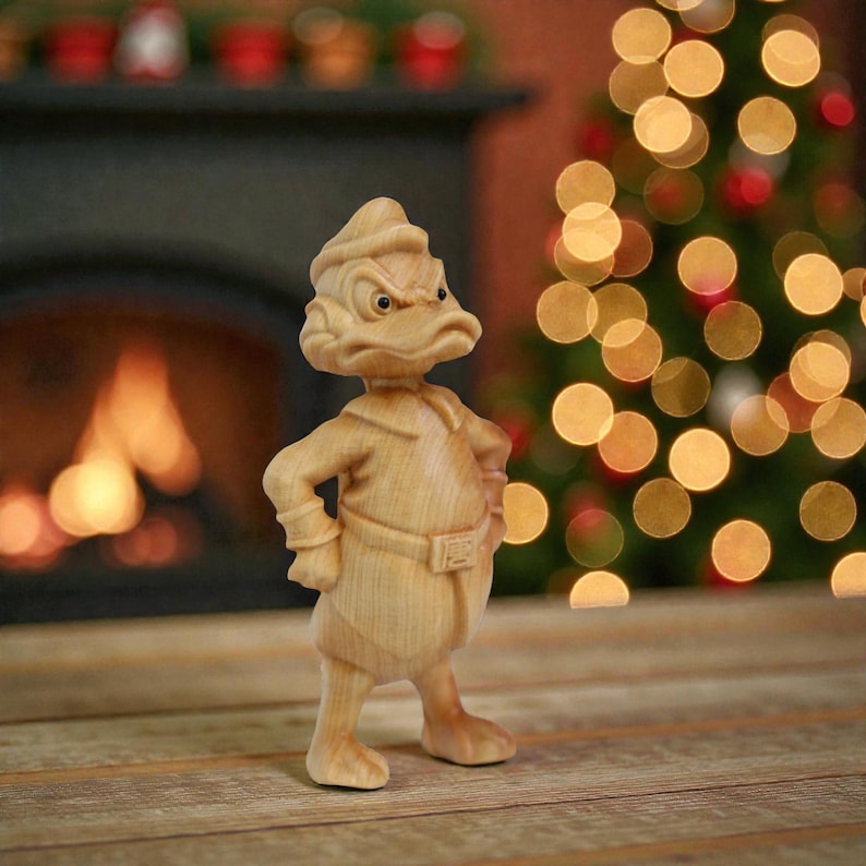 May include: A wooden figurine of a duck-like character with an angry expression, wearing a hat and a belted outfit. The figure is standing on a wooden surface, with a blurred background of a fireplace and Christmas tree lights.