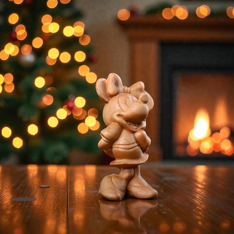 May include: A wooden figurine of Minnie Mouse, standing on a reflective surface. The figure is carved from light-colored wood and features Minnie's signature bow and dress. A Christmas tree with blurred lights and a fireplace are in the background.