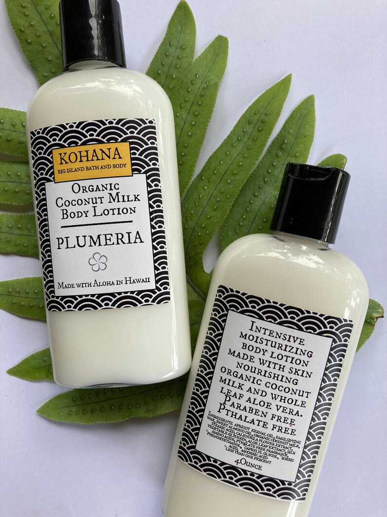 May include: Two white body lotion bottles with black caps and labels. The labels read "KOHANA" and "Organic Coconut Milk Body Lotion" with "Plumeria" below. The other bottle reads "Intensive Moisturizing Body Lotion". The bottles are 4 ounces.