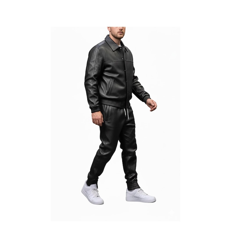 May include: A black leather jacket with a collared neckline and matching black leather pants. The jacket has a button-up front and ribbed cuffs. The pants have a drawstring waist and ribbed ankle cuffs. White sneakers complete the outfit.