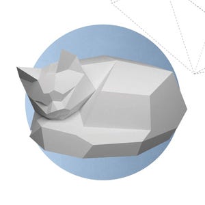 May include: A set of three ceramic mugs with a speckled, matte finish. The mugs are in shades of cream, light gray, and dark gray. Each mug has a simple, minimalist design and a rounded handle.