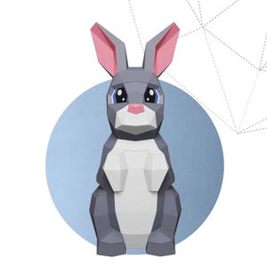 May include: A geometric papercraft rabbit in shades of gray, white, and pink, set against a light blue circle. The words "CUTE RABBIT" are below the rabbit. The image includes the Instagram handle and copyright information.
