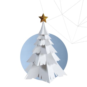 May include: A white paper Christmas tree with a gold star on top, set against a light blue circle. The words "CHRISTMAS TREE" are below the tree in a bold, outlined font. The background is white.