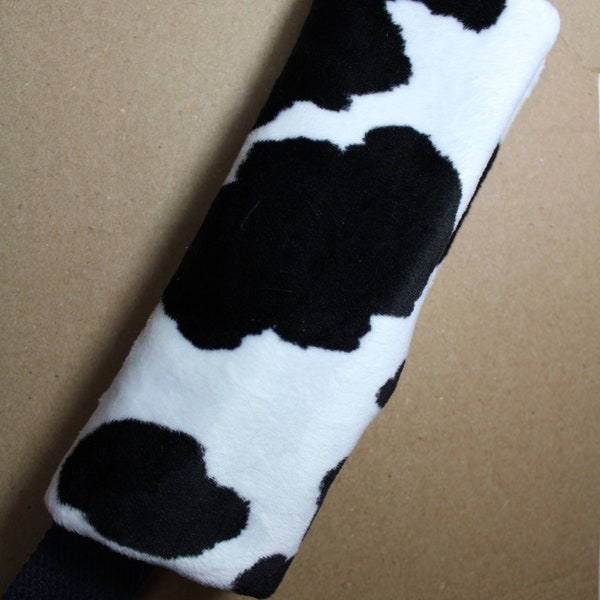 Super soft seat belt cover in cow print.