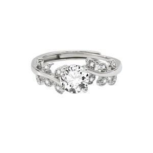 May include: A silver-toned ring featuring a large, round, clear gemstone at the center. The ring is adorned with smaller, clear gemstones and leaf-like designs on the band, creating an elegant and nature-inspired aesthetic.