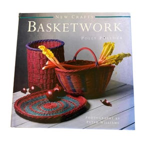 May include: A hardcover book titled New Crafts Basketwork by Polly Pollock with photography by Peter Williams. The cover features a tall red woven basket, a round red and blue woven basket, and a flat woven tray with red onions and yellow greens.