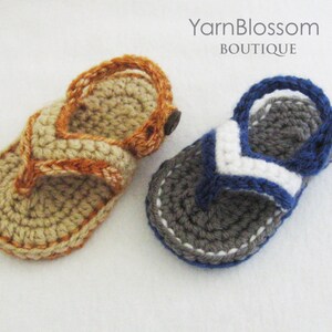 May include: Two pairs of crocheted sandals, one in beige with orange accents and one in gray with blue and white accents. Yarn Blossom Boutique.