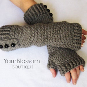 May include: Gray crocheted fingerless gloves with black buttons. Yarn Blossom Boutique.