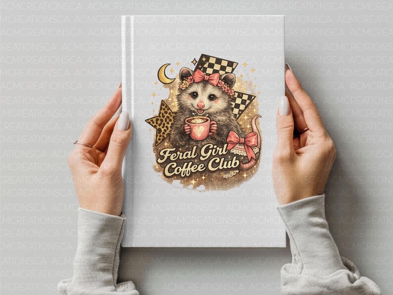 May include: A notebook with a whimsical illustration of an opossum holding a coffee cup, adorned with a floral headband and a pink bow. The text "Feral Girl Coffee Club" is featured below the opossum. The design includes a star and checkered flag.