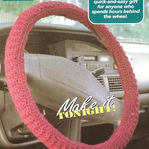 May include: A pink crocheted steering wheel cover. The cover is made with a simple stitch pattern and is a quick and easy project. The text "Make it TONIGHT!" is printed on the image.