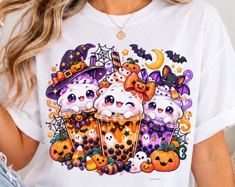 May include: A white t-shirt featuring a colorful graphic print of three cute boba tea cups with faces, surrounded by Halloween elements including pumpkins, a witch hat, bats, a spider web, candy corn, and a crescent moon.