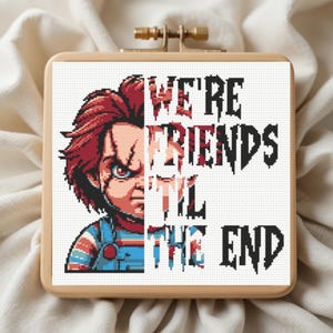 May include: A cross-stitch design in a wooden hoop features the character Chucky from the horror film series, with the text "WE'RE FRIENDS TIL THE END". The design uses red, blue, and black thread on a white background.