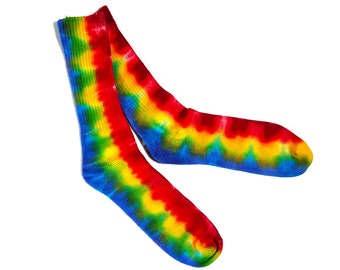 May include: A pair of colorful tie-dye socks with red, yellow, blue, and green swirls. The socks are made of a soft, comfortable material and are perfect for adding a pop of color to any outfit.