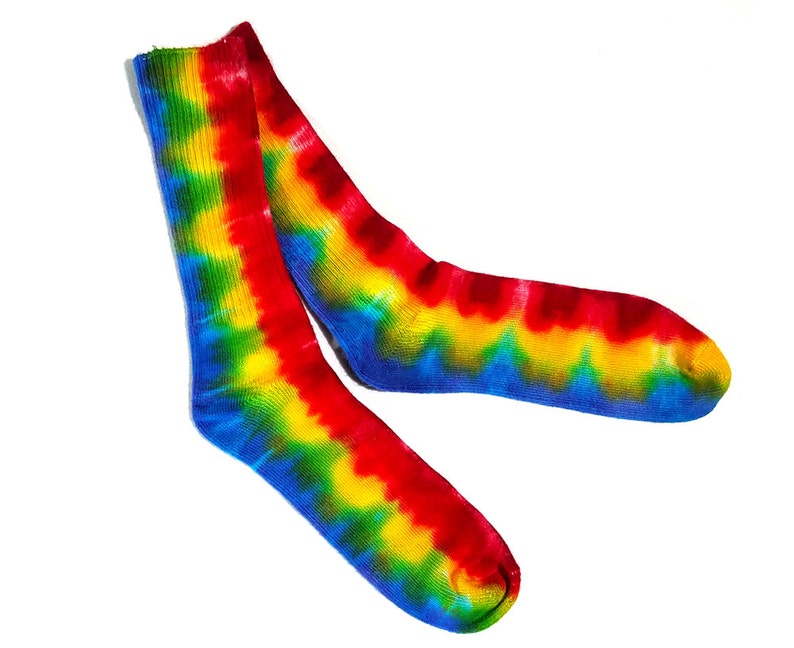 May include: A pair of colorful tie-dye socks with red, yellow, blue, and green swirls. The socks are made of a soft, comfortable material and are perfect for adding a pop of color to any outfit.