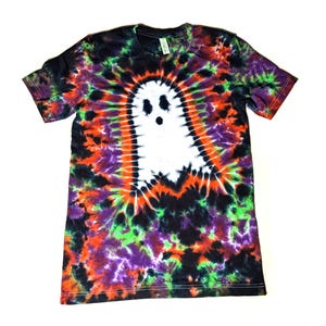 May include: A black, green, orange, and purple tie-dye t-shirt with a white ghost design in the center.