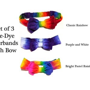 May include: Set of three tie-dye hairbands with bows in classic rainbow, purple and white, and bright pastel rainbow designs. The text "Set of 3 Tie-Dye Hairbands with Bow" is visible.