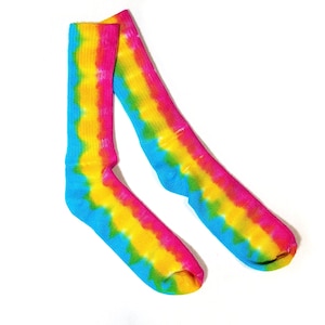 May include: A pair of colorful tie-dye socks with blue, yellow, and pink stripes. The socks are made of a soft, comfortable material and are perfect for adding a pop of color to any outfit.