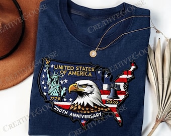 May include: Navy blue t-shirt featuring a patriotic design for the 250th anniversary of the United States. The graphic includes an eagle, the Statue of Liberty, and the Liberty Bell, with the text "United States of America".