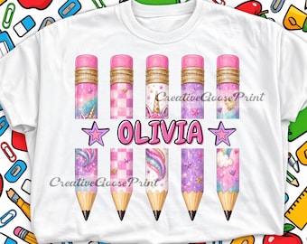 May include: A white t-shirt featuring a graphic print of five pencils with pink erasers. The pencils display patterns of unicorns, stars, hearts, and checkered designs in shades of pink and purple. The name OLIVIA is printed in pink letters.