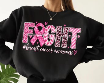 May include: A black long-sleeve sweatshirt featuring the word FIGHT in large, pink-patterned letters, with the letter I replaced by a pink awareness ribbon. Below, the text #breast cancer awareness is printed in white cursive script.