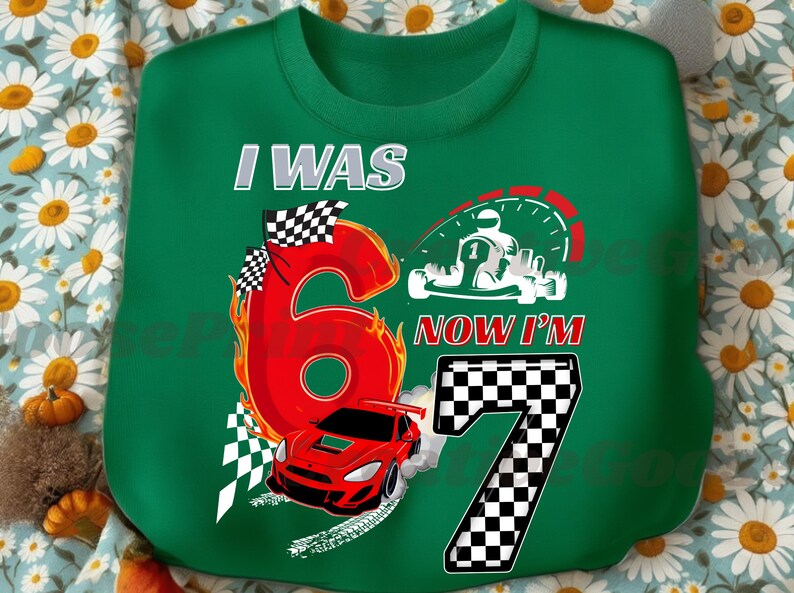 May include: Green sweatshirt with a racing theme. Features the text "I WAS 6 NOW I'M 7" with a large red number 6 on fire, a red race car, and a checkered flag. Includes a graphic of a go-kart.