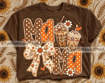 May include: A brown t-shirt featuring a graphic print with the word Mama in large polka-dot letters, two iced coffee drinks with whipped cream, a large decorative bow, and small flower accents in shades of orange, brown, and white.
