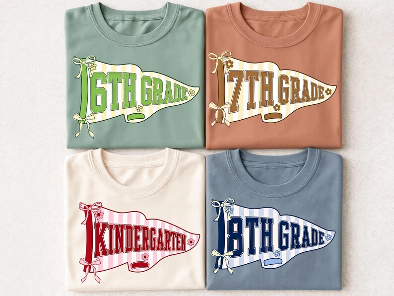 May include: Four crew neck t-shirts in sage green, terracotta, cream, and slate blue. Each shirt features a pennant graphic with a striped background, ribbon bows, and small flowers. The text reads 6TH GRADE, 7TH GRADE, KINDERGARTEN, and 8TH GRADE.