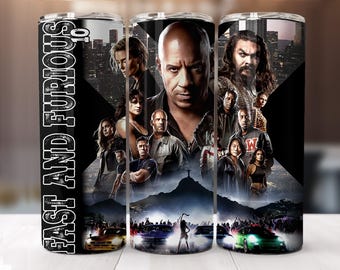 May include: A stainless steel tumbler featuring a collage of characters from the "Fast and Furious" movie franchise. The design includes images of actors, cars, and cityscapes, with the words "Fast and Furious" printed vertically in white on a black background.