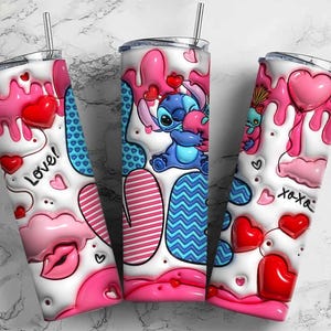 May include: Three stainless steel tumblers with lids and straws. Each tumbler features a white base with pink and red heart and drip designs. One tumbler has the word "Love!" and another has "xoxo" text. The center tumbler has a blue cartoon character.