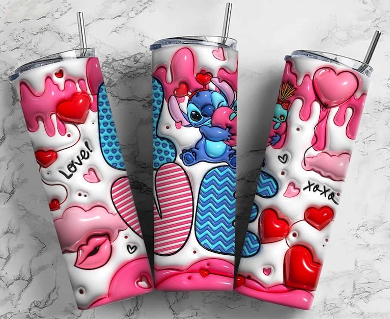May include: Three stainless steel tumblers with lids and straws. Each tumbler features a white base with pink and red heart and drip designs. One tumbler has the word "Love!" and another has "xoxo" text. The center tumbler has a blue cartoon character.