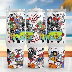 May include: White insulated travel mug with a Halloween design. The design features cartoon characters in a Scooby-Doo-style van, bats, spiderwebs, and pumpkins. The mug has a white handle and lid, ideal for cold drinks.