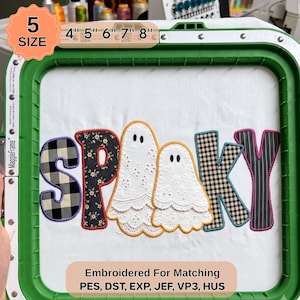 May include: An embroidery design in a green hoop featuring the word SPOOKY with two white eyelet lace ghosts replacing the letter O. The letters feature black and white buffalo check, black floral, and black pinstripe fabric patterns.
