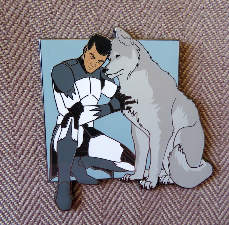 May include: A white and gray enamel pin featuring a cartoon character in a white and black uniform hugging a white wolf. The character has a red scar on their face.