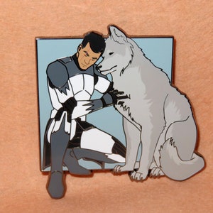 May include: A white and gray enamel pin featuring a cartoon character in a white and gray uniform hugging a white wolf. The character has dark hair and a serious expression.