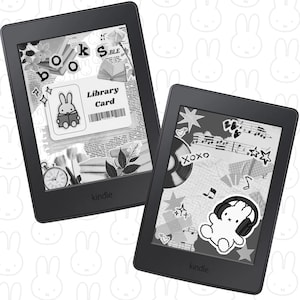 May include: Two black Kindle e-readers with decorative screens. One shows a library card graphic with a bunny reading a book, the other displays a bunny wearing headphones. Both have the word "kindle" printed at the bottom.